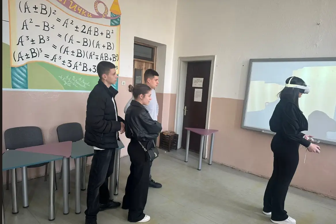 Students watching a classmate use a VR headset while the virtual environment is shown on the classroom screen during the Long-Term Teaching/Learning Assignments in North Macedonia